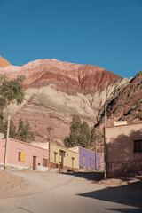 Adobe houses in Pumamarca Argentina with 7 colours mountain view at back