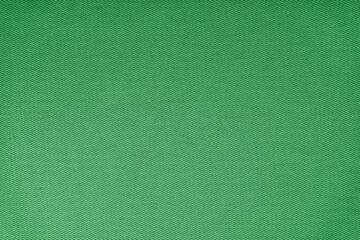 Texture of natural green fabric or cloth. Fabric texture diagonal weave of natural cotton or linen textile material. Blue canvas background. Decorative fabric for curtain, furniture, walls, clothes