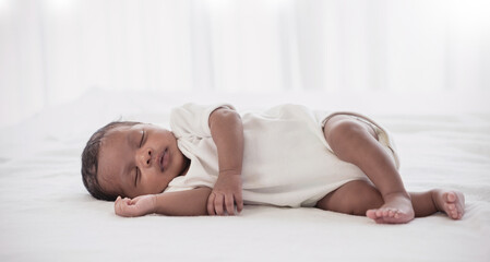 Portrait of African American  newborn baby body sleeping in bed. Closeup new born baby. Love family healthcare and medical body part nursery together happy mother’s day concept