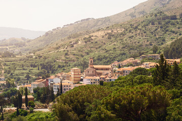 Fototapeta premium Capoliveri has unusual architecture, the town still retains its medieval appearance, with its narrow, picturesque vineyards and arcades known as chiassi. Island of Elba, Italy