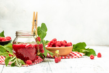 Raspberry jam with berry on light background. Homemade jam with raspberry. banner, menu, recipe place for text, top view