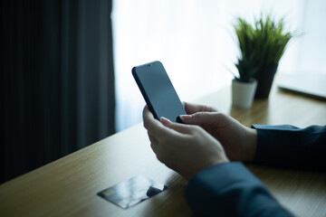 Hand holding credit card and using computer. Shopping online, e-commerce, internet banking, working from home concept.