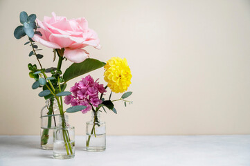 Fototapeta premium Flowers in vase with beautiful pink roses, yellow dahlia and pink hydrange bouquet, copy space.Greeting card.