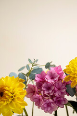 Floral composition greeting card mock up. Pink and yellow flowers with copy space. Hydrangea, dahlias and eucalyptus. © Inga