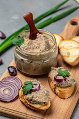 Toasts bread with beans paste, Mexican cuisine pate of beans in glass jar. healthy vegetarian food, vertical image. top view. place for text