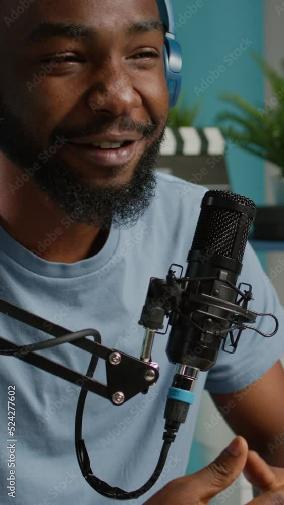 Aufkleber vertical video: close up of vlogger using microphone and headphones to record vlog for channel. posi
