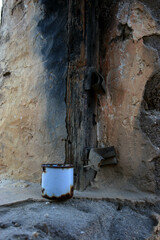 A photo of a tin cup in an abandoned wall where Italian prisoners of war stayed where they built a mountain pass. The prisoners of war's legacy in South Africa was the many construction projects they 
