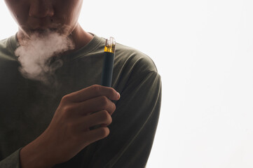 Young man on a white background smoking electronic cigarette, enjoying, a lot of smoke