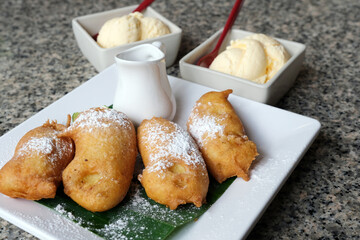 Fried bananas sprinkled with sugar and honey
