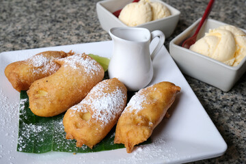 Fried bananas sprinkled with sugar and honey