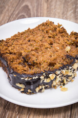 Pastry made of zucchini with nuts and raisin on plate. Delicious dessert