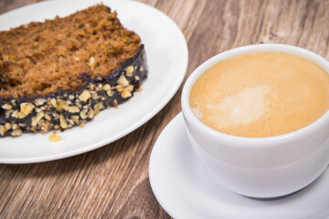 Fresh pastry made of zucchini and cup of white coffee. Delicious dessert. Wooden background