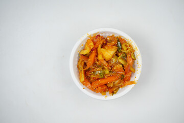 Homemade chili Pickle in a bowl on white 