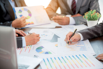 Group professional business people person working together to analyze in office, work together to discuss company financial statistics report, brainstorm ideas, and graph datum documents on the table.