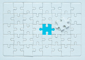 White part of jigsaw puzzle pieces on blue background. concepts of problem solving, business...