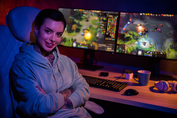 Profile photo of attractive hipster gamer girl sit chair crossed arms toothy smile enjoy late night gaming studio indoors © deagreez
