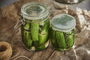  Salted, pickled cucumbers in a jar on an old wooden table