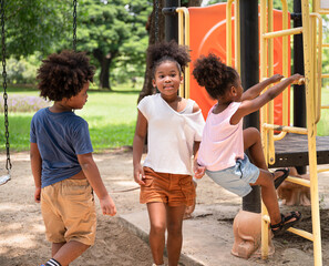 African American kids girl playing in adventure zone playground at the park