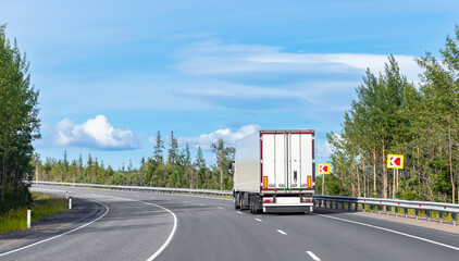 Truck transportation on island Finland road at sunny day. Concept banner logistic cargo speed