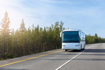 White buses traveling on asphalt highway background forest with sun light