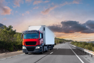 Fototapeta na wymiar Truck transportation on island Finland road at sunset light. Concept logistic cargo speed