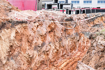 Dig a trench. Earthworks, digging trench. Long earthen trench dug to lay pipe or optical fiber....