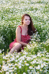 Naklejka na ściany i meble Russia. Saint-Petersburg. Country recreation of citizens. A girl in a field with daisies.