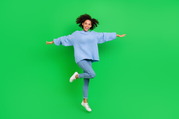 Fototapeta na wymiar Full length portrait of active charming person arms wings flight jumping isolated on green color background