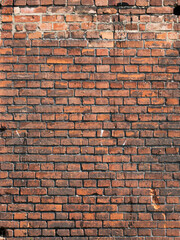 Fototapeta premium Brick wall background. Pattern brown color design decorative uneven cracked real stone wall surface with cement. Dry brick wall as seamless background