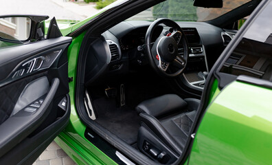 View to inside of modern salon of car through open door.