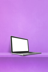 Laptop computer on purple shelf. Vertical background