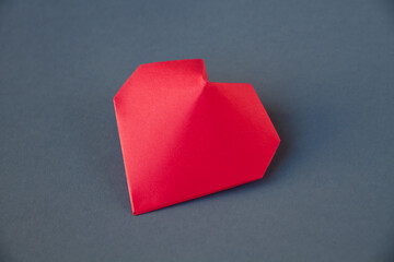 Red paper heart origami isolated on a grey background