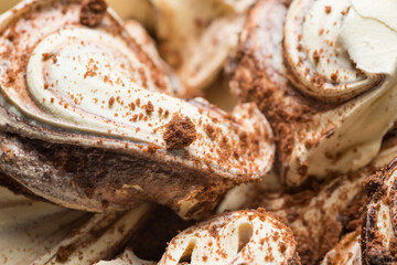 Frozen Cookie flavour gelato - full frame detail. Close up of a white and brown surface texture of ...