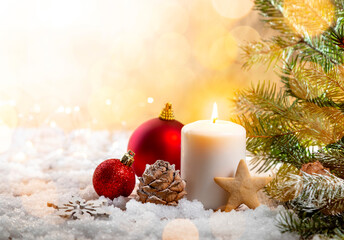 Christmas candle on snow-covered boards - decoration with natural elements, twigs, pine cones, Christmas decorations.