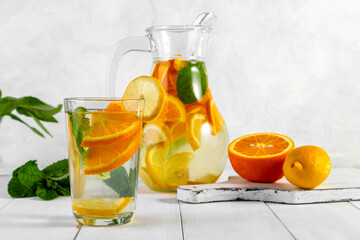 Citrus drink with lemon, orange and mint. Healthy and healthy drink in a transparent glass with copy space
