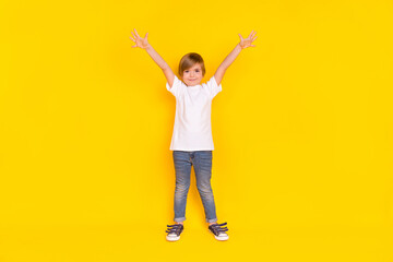 Fototapeta na wymiar Full length body size view of handsome cheerful funky pre-teen boy rising hands up isolated over shine yellow color background