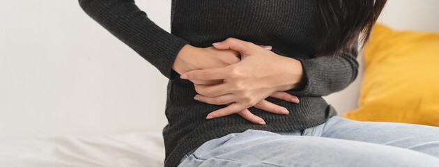 close up woman suffering stomach pain from food poisoning.