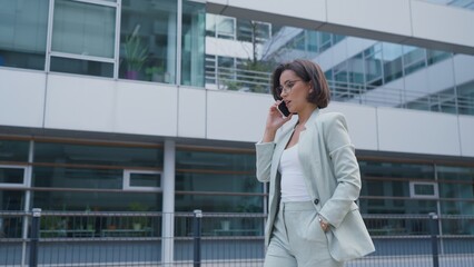 Successful female going to office in modern business center