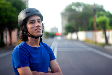 Guy on his bike on the street looking at the camera and smiling in the afternoon in Venezuela