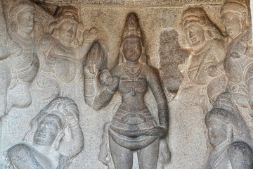 Bas relief rock cut sculptures of gods, people and animals are carved prominently in the monolithic...