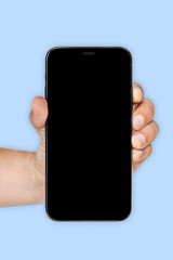cell phone in hand with blue background