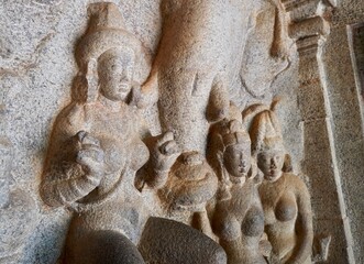 Fototapeta na wymiar Bas relief rock cut sculptures of gods, people and animals are carved prominently in the monolithic cave temples at Mahabalipuram, Tamil nadu, India