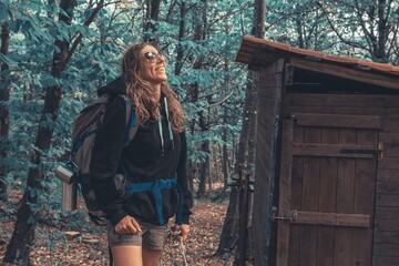 woman walks in the woods with backpack