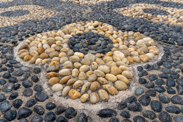 Chinese pebble decorative walkway of artistic designs and mosaic. Reflexology paths. Walking path...
