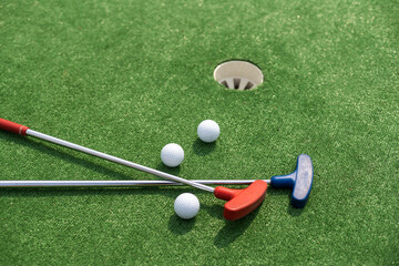 A club prepares to hit a ball during a mini golf game