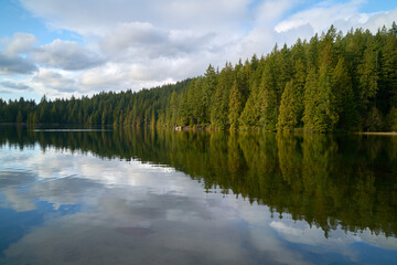 Sasamat Lake Calm Reflection British Columbia. Sunshine and mist on Sasamat Lake in Port Moody, British Columbia.

