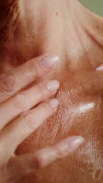 Elderly Woman Applying Moisturizer To The Décolleté Area, Close-up, No Face, Vertical Video