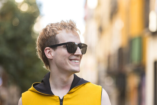 Smiling stylish non binary male on street
