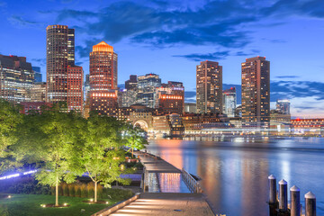 Boston, Massachusetts, USA downtown city skyline and pier at twilight.