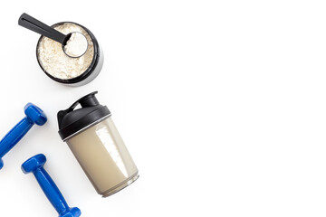 Sport bottle and jar of powder whey protein and dumbbells. Fitness and gym diet